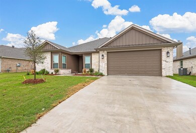 View of front of home featuring central air condit
