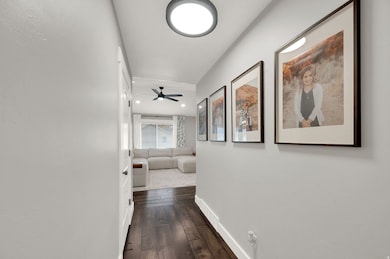 Hallway featuring dark wood-style floors and recessed lighting