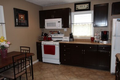 The eat-in kitchen features an abundance of cabine