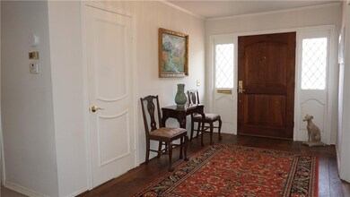 Wide Entry with wood floors and coat closet