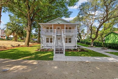 View of front of house featuring stairway, a porch, and a front lawn