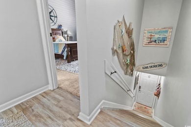 Stairs featuring wood finished floors