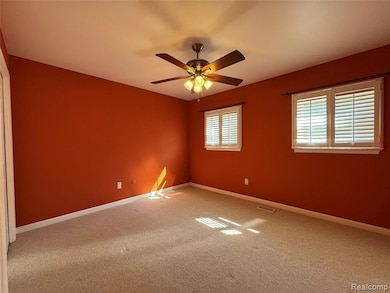 Unfurnished room with carpet floors and ceiling fan