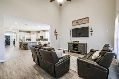 This lovely living room offers plenty of natural light and high ceilings.