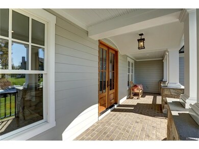 Brick paver covered front porch and mahogany doors