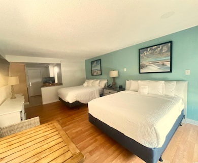 Bedroom featuring baseboards, wood finished floors