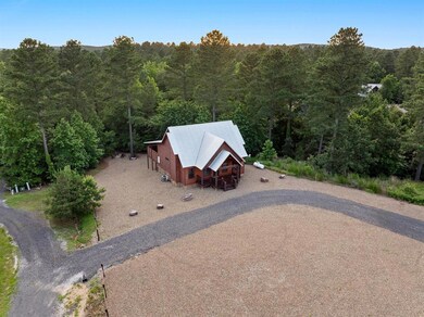 Aerial view of property and surrounding area featuring a forest