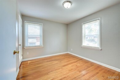 Unfurnished bedroom with light wood-style floors and plenty of natural light