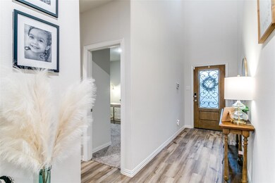 Entryway featuring a high ceiling and light hardwo