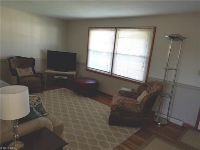 Living room offers hardwood flooring, lots of natu