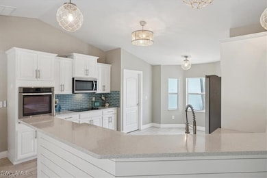 Kitchen with stainless steel appliances, vaulted c