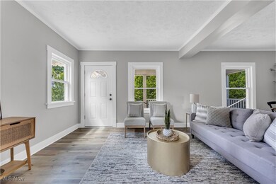 Living room with a textured ceiling and hardwood / wood-style floors
