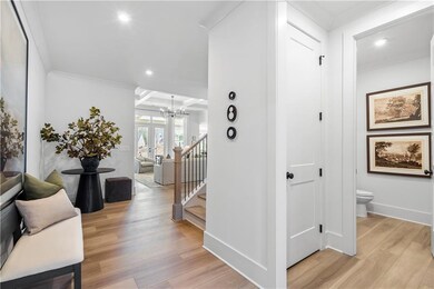 Hall with a chandelier, recessed lighting, light w