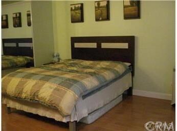 Master bedroom w/crown molding & wood flooring