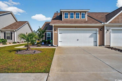 View of front of house with driveway and a front lawn