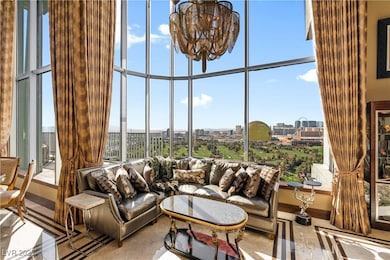 Living area with a view of city, a chandelier, and