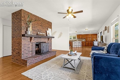 Living area with a wood stove, baseboards, light w