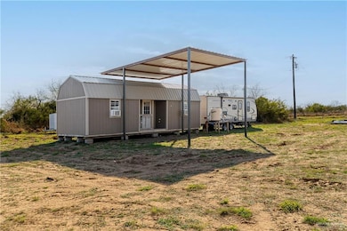 View of yard with an outbuilding and a detached carport