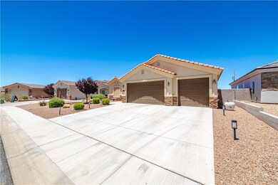 View of front of home with a garage, driveway, sto