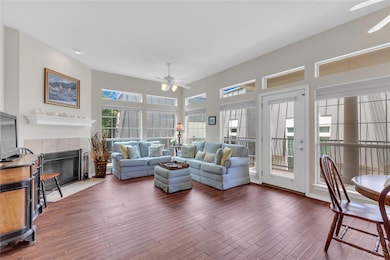 Living room featuring ceiling fan, hardwood / woo