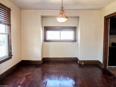 Formal dining room with wood flooring.