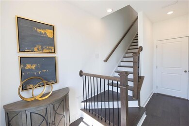 Hard surface flooring upon entry - hardwood stairs - great area to come into - furniture not included   Pictures are for representation only, not the actual home