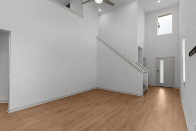 Entryway featuring a ceiling fan, light wood-type