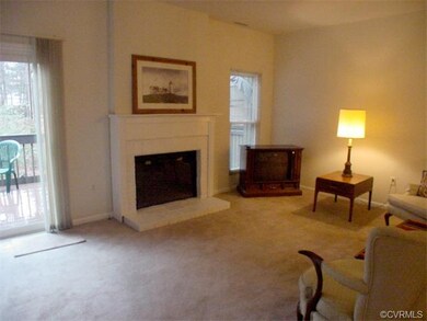 Living room with wood-burning fireplace and slidin