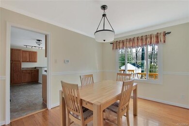 Formal dining room with wood floor, crown molding,