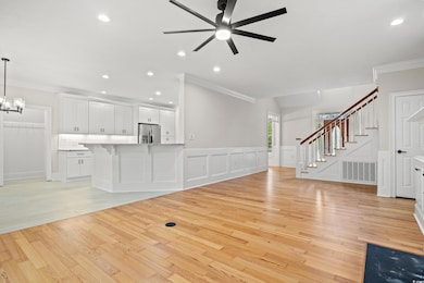 Unfurnished living room featuring ornamental moldi