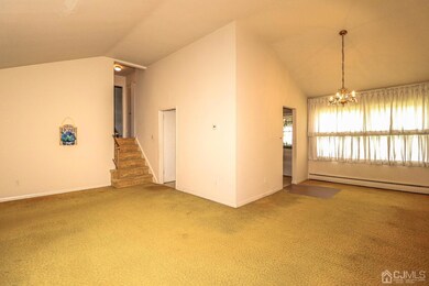 Open floor plan!  Living room and Dining room with vaulted ceilings plus wall to wall carpeting over wood floors.