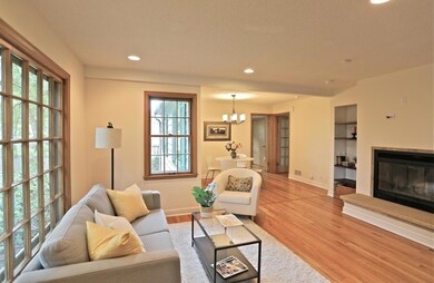 Sunny open living room with hardwood floors