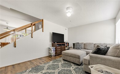 Living room featuring stairs, ceiling fan, a textu