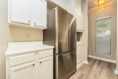 Kitchen featuring freestanding refrigerator, ligh