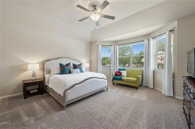 Bedroom with light colored carpet and ceiling fan