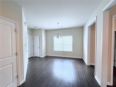 Empty room with dark wood-style flooring