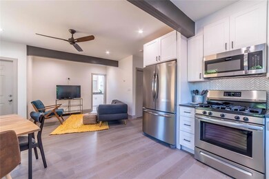 Kitchen featuring a ceiling fan, appliances with 