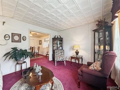 Carpeted living room featuring baseboards