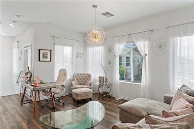 Office space with a chandelier, wood finished floo