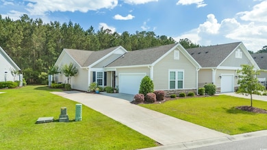 View of front of property featuring a garage, conc