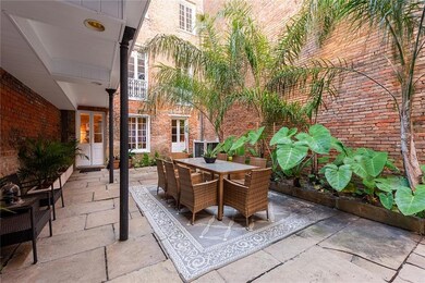 Enter condo #104 through the shared courtyard