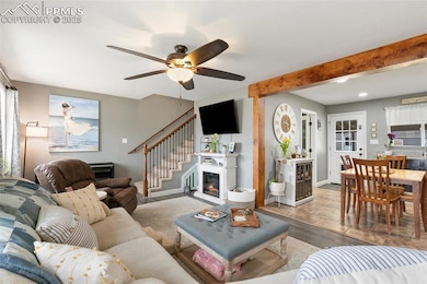 The Living Room is a cozy oasis with ceiling fan and is open to the Kitchen.