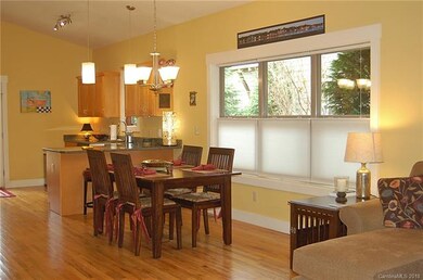 View of the open living room from front entry. Hardwood floors throughout.