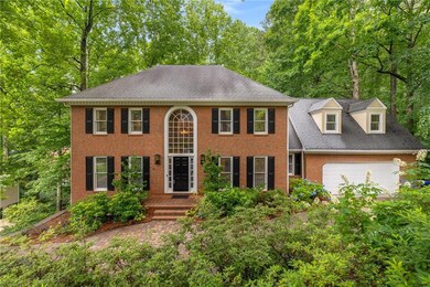 Colonial inspired home with brick siding, and a private yard