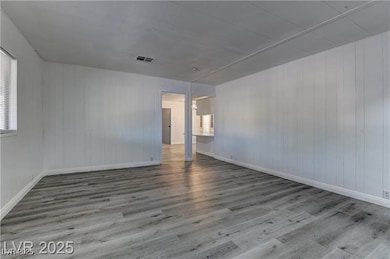 Empty room with wood finished floors and wooden walls
