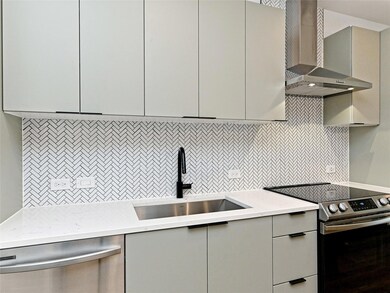 Kitchen with stainless steel appliances, wall chi