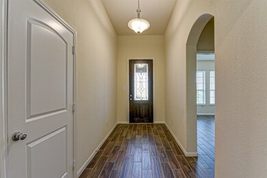 Enter to a welcoming airy light-filled hallway with Gleaming wood tile floors throughout.