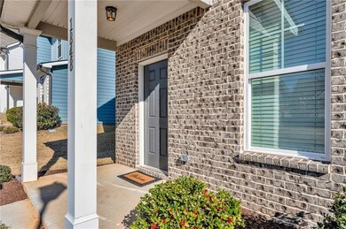 Doorway to property featuring brick siding
