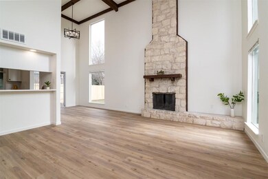 Unfurnished living room with high vaulted ceiling