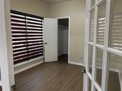 Unfurnished bedroom with dark wood-type flooring a